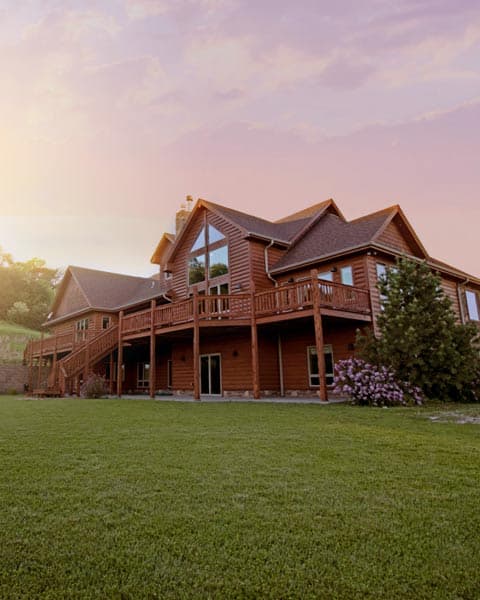 Large lawn in front of a wooden house