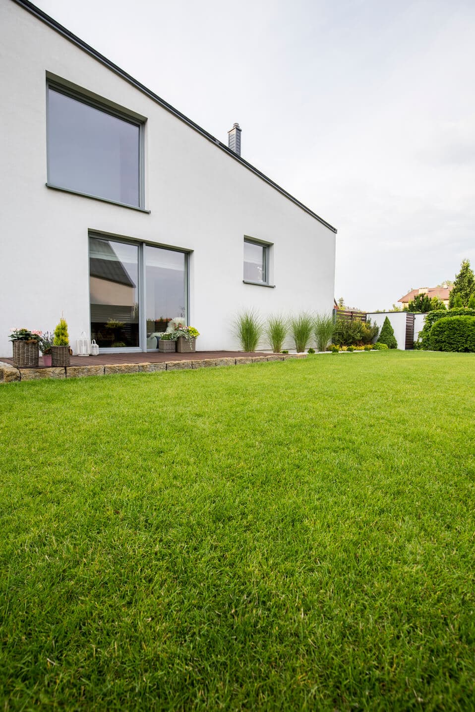 Green lawn beside a modern white house